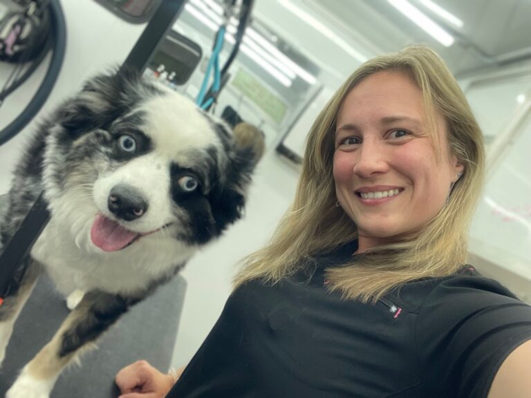 groomer taking a selfie with a dog